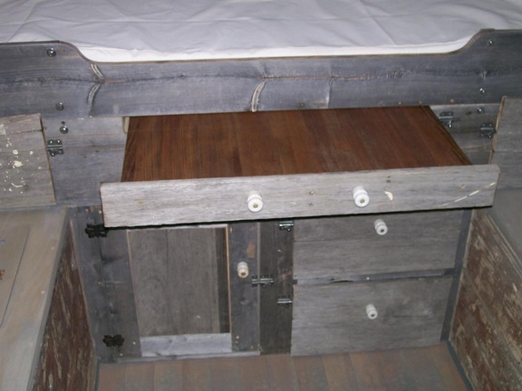34.  Barnwood bed front, table and drawers and door under bed