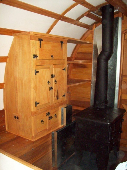 43. Cabinet with wood shelves and stove on floor